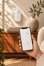 Hand holding a phone with the Smart Life app timer in front of the Urthy Mist plug-in